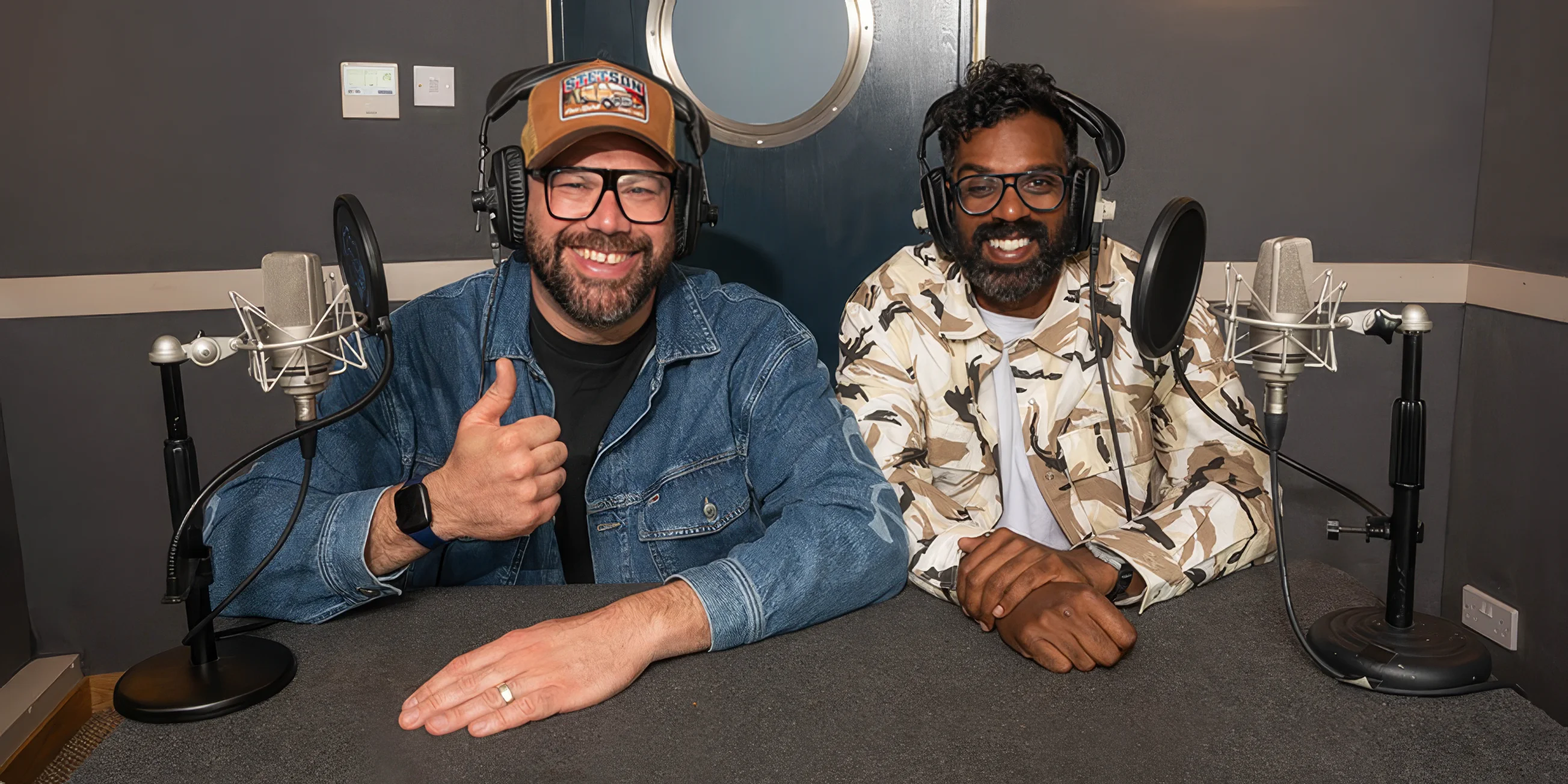 Romesh and Tom in a studio, while recording their voice-over for Takeshi's Castle